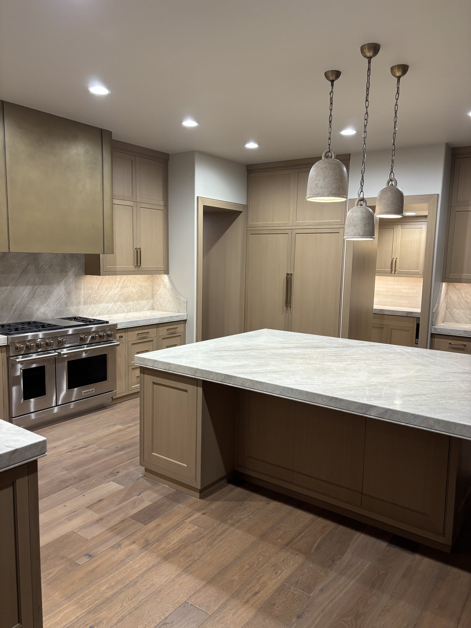 Completed Hilltop kitchen island, cabinetry, and professional range