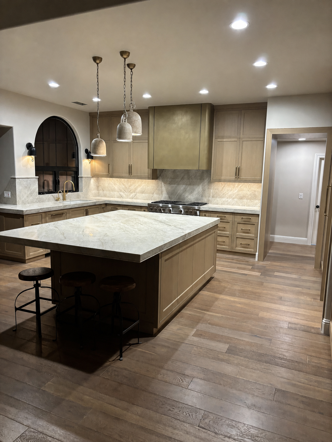Completed Hilltop kitchen with custom cabinetry, stone surfaces, and a large island